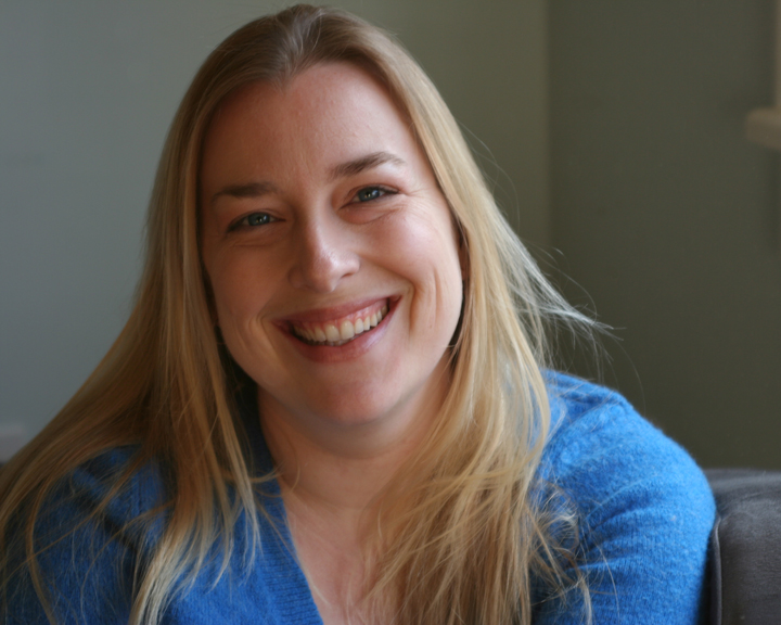 Joanna Strange smiling in a blue sweater